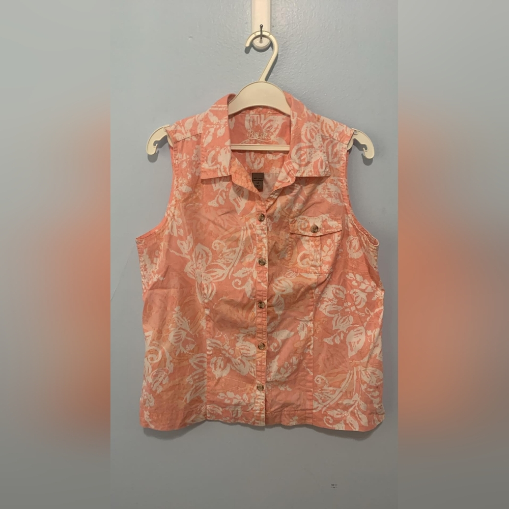 Brisa’s coral flowered short sleeve blouse